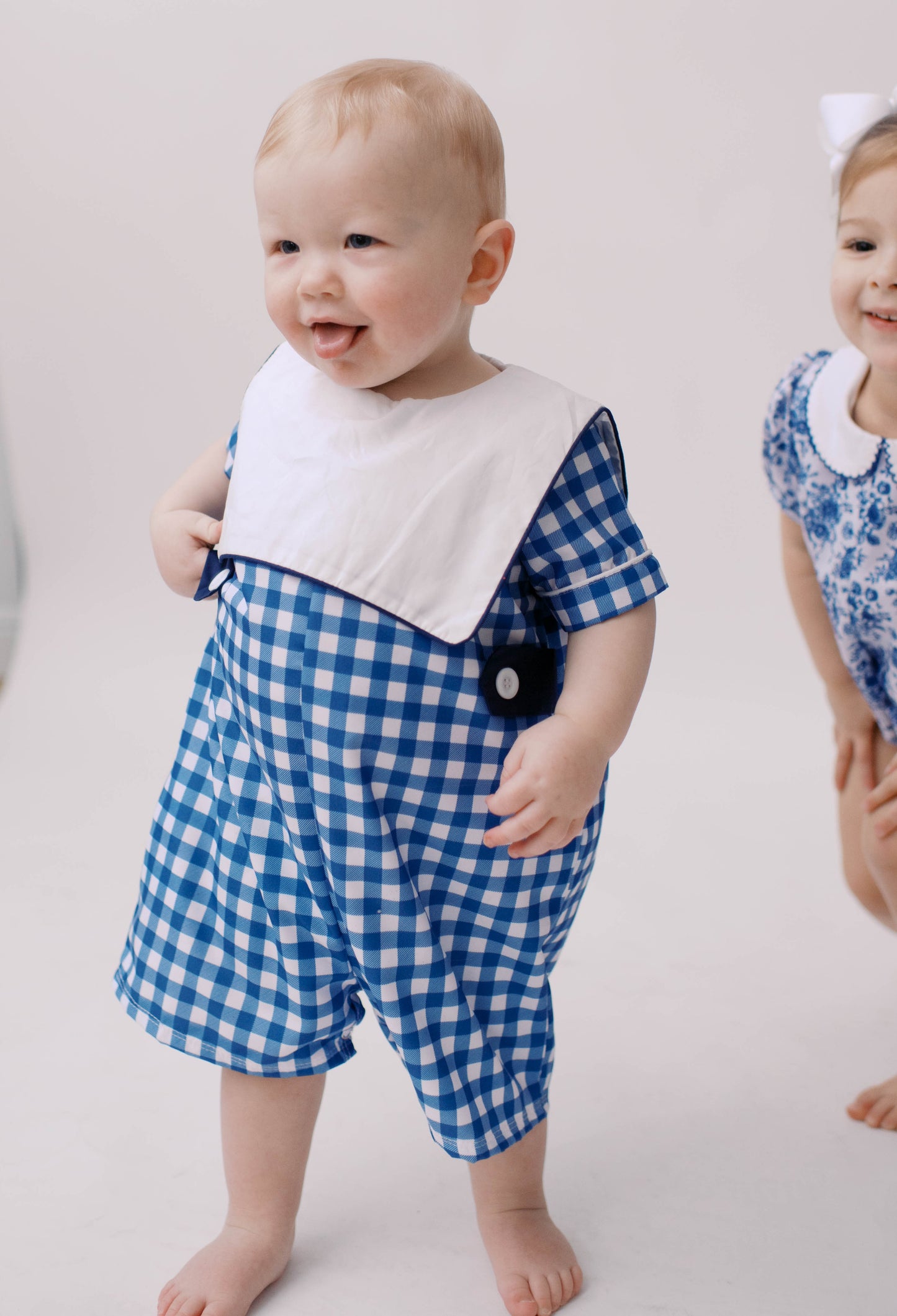 Baby boys blue gingham shortall playsuit.