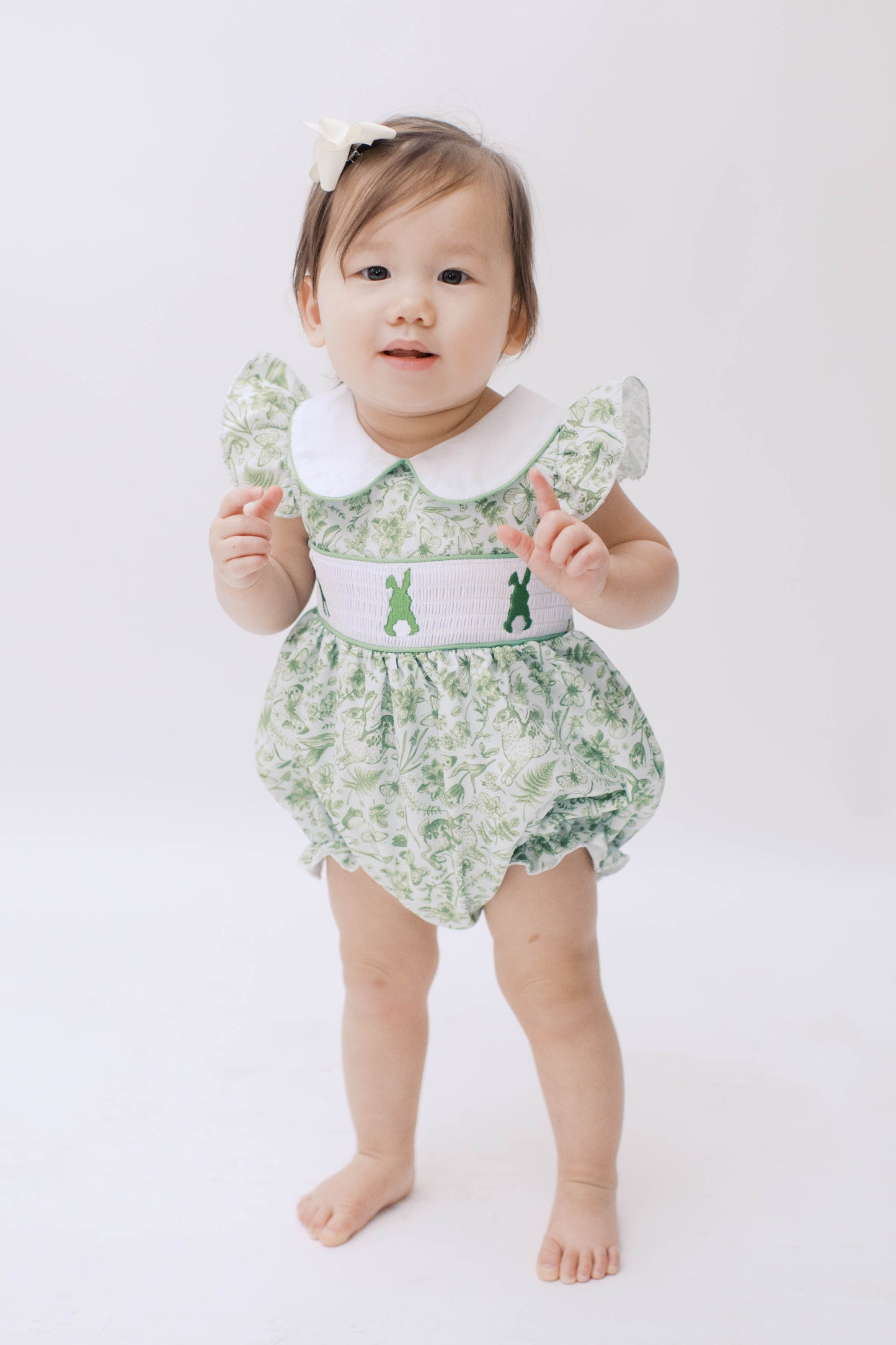 Green toile baby girl easter bubble with bunny smocking and ruffle sleeves.