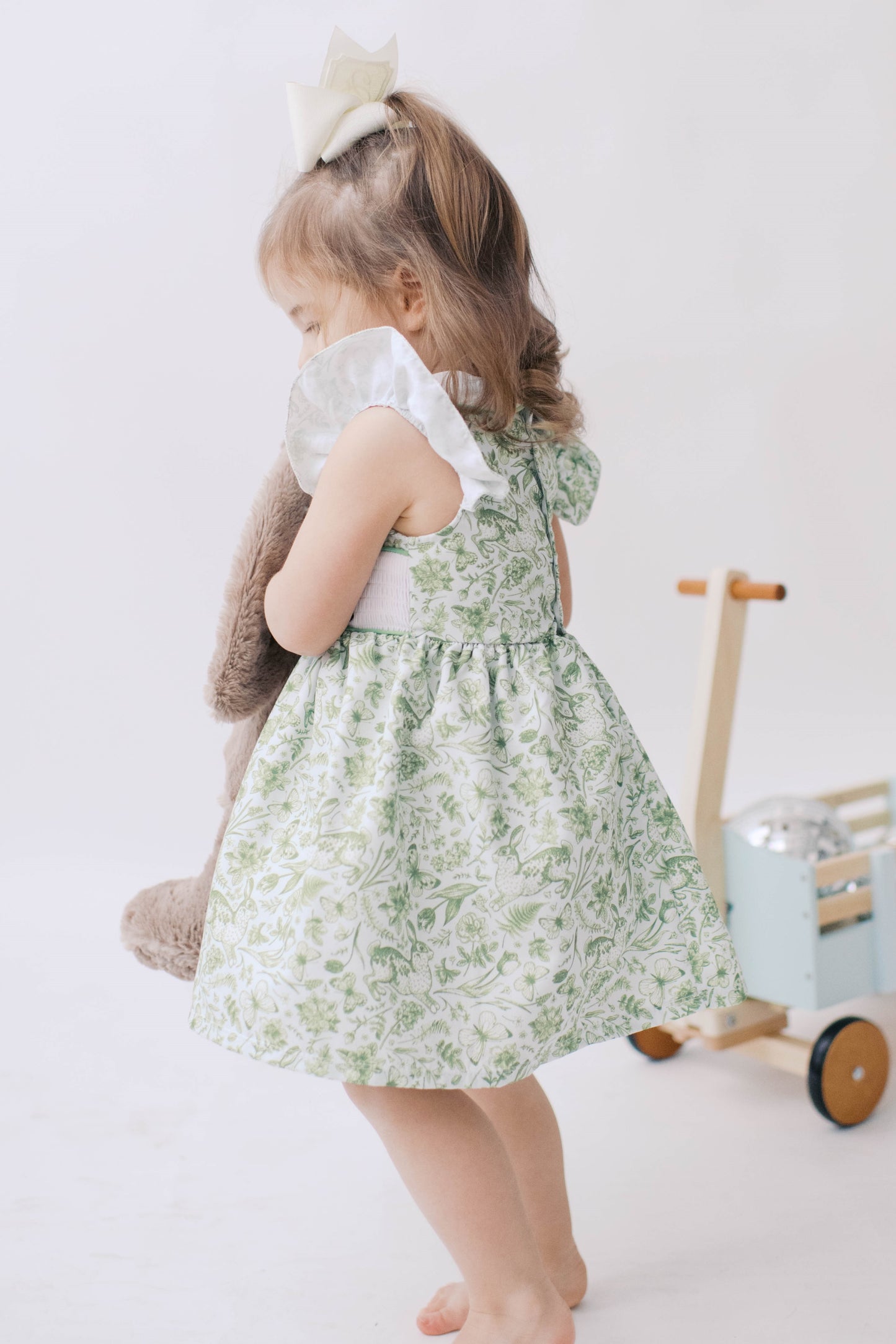 Green toile girl Easter dress with smocked bunnies and ruffle sleeve.