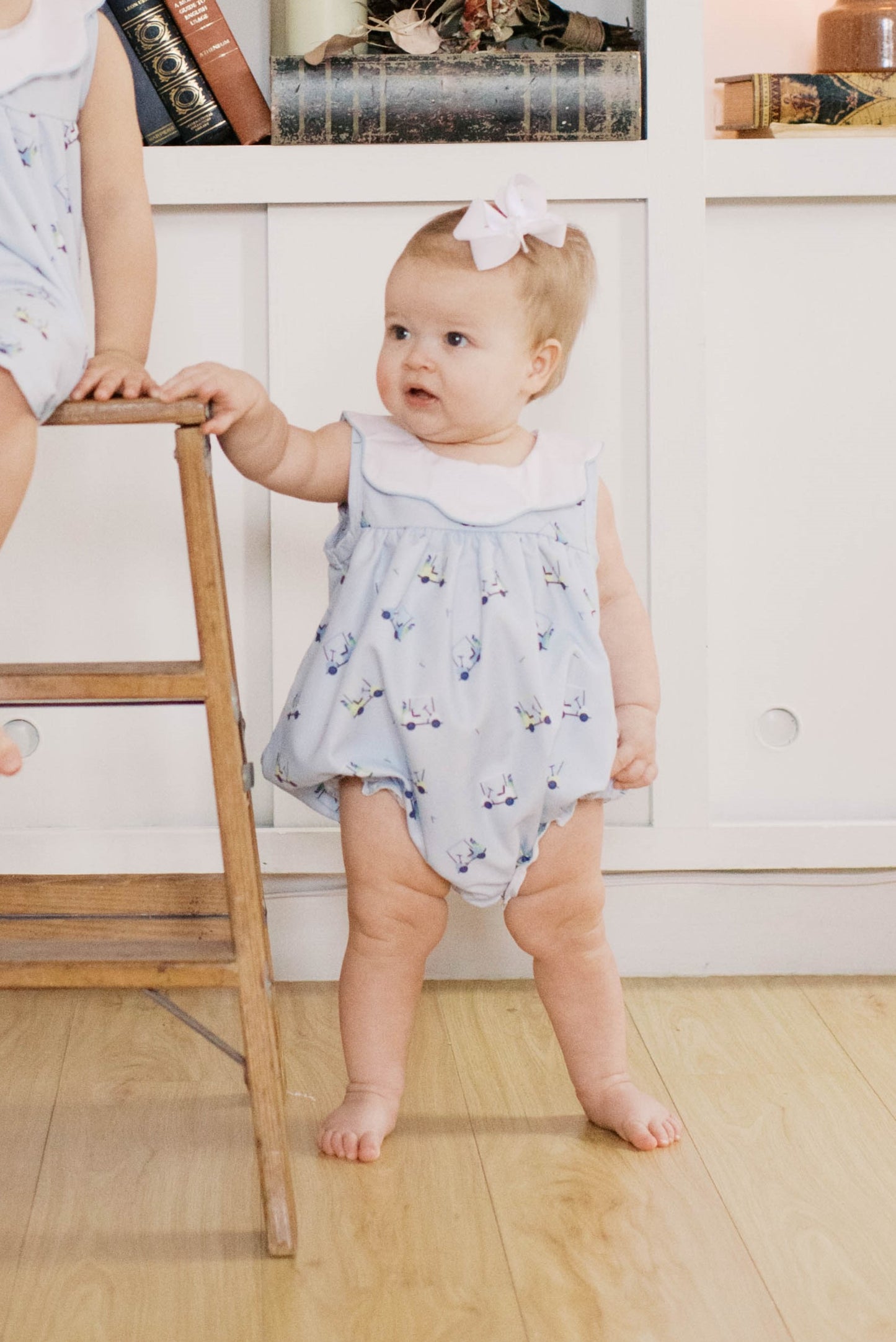 Baby girls blue golf bubble outfit.